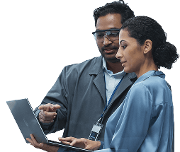 Two project managers reviewing data on a laptop.