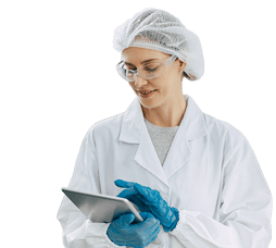 A cleanroom technician reviewing data on her tablet.