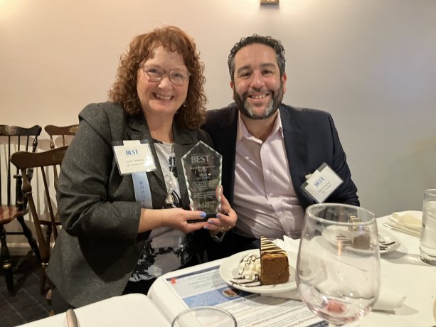 Pictured accepting the award on behalf of the team are Jody Frawley and Herb Escher.