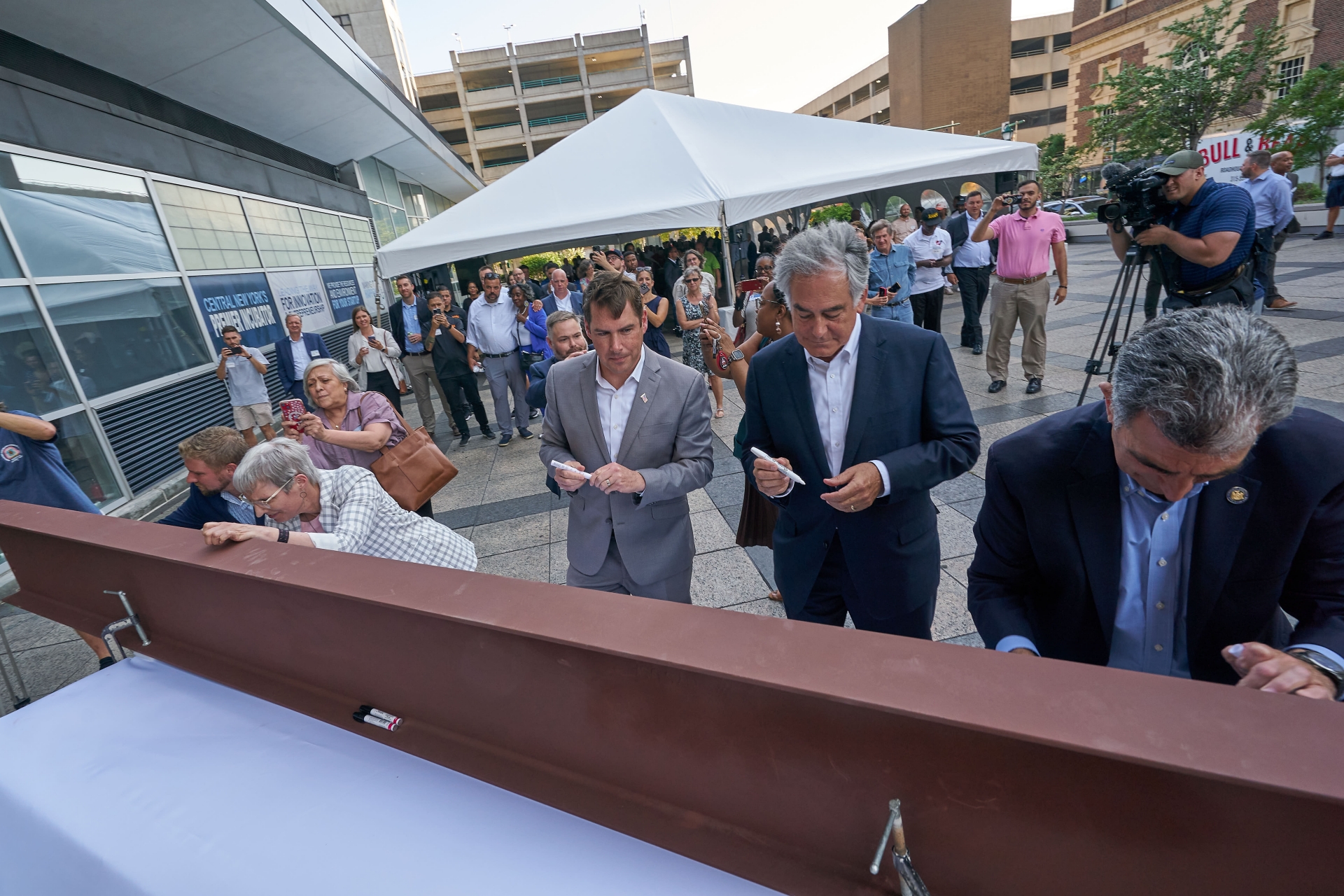 Elected officials sign a steel beam at The Tech Garden Expansion Kickoff. 